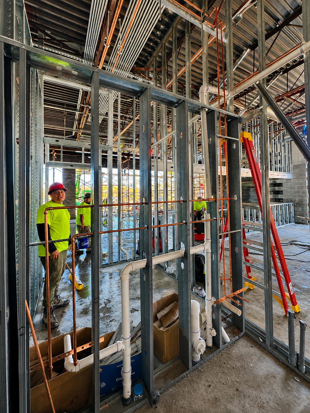 Interior wall rough-in with PVC DWV, copper water piping and Webster & Sons crew at Mavis Tires & Brakes Greensboro
